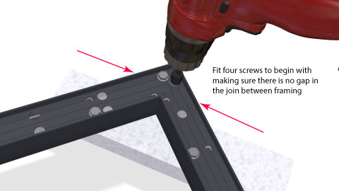 Close shot of the corner bracket being screwed up showing the pattern of screws and the builders square