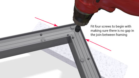 Close shot of the corner bracket being screwed up showing the pattern of screws and the builders square